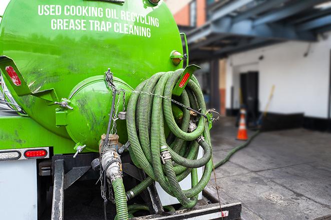 a service truck pumping grease from a restaurant's grease trap in Brockton